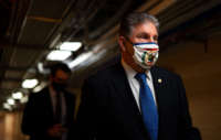 Sen. Joe Manchin walks on the senate side of the Capitol Building on March 5, 2021, in Washington, D.C.