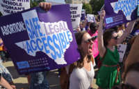 Abortion rights activists hold placards and chant outside of the Supreme Court ahead of a ruling on abortion clinic restrictions on June 27, 2016, in Washington, D.C.