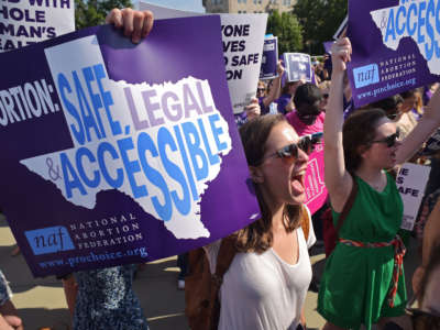 Abortion rights activists hold placards and chant outside of the Supreme Court ahead of a ruling on abortion clinic restrictions on June 27, 2016, in Washington, D.C.