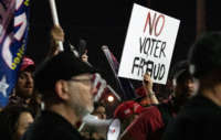 A "no voter fraud" sign is displayed by a protester at the Maricopa County Elections Department office on November 4, 2020, in Phoenix, Arizona.