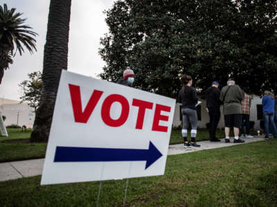 People stand in line to vote outside the Main Street Branch Library vote center on November 3, 2020, in Huntington Beach, California.