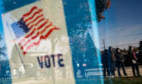 People wait in line to cast their absentee ballots in person at the Sterling Heights Election Center located in the Senior Center in Sterling Heights, Michigan, on November 2, 2020.