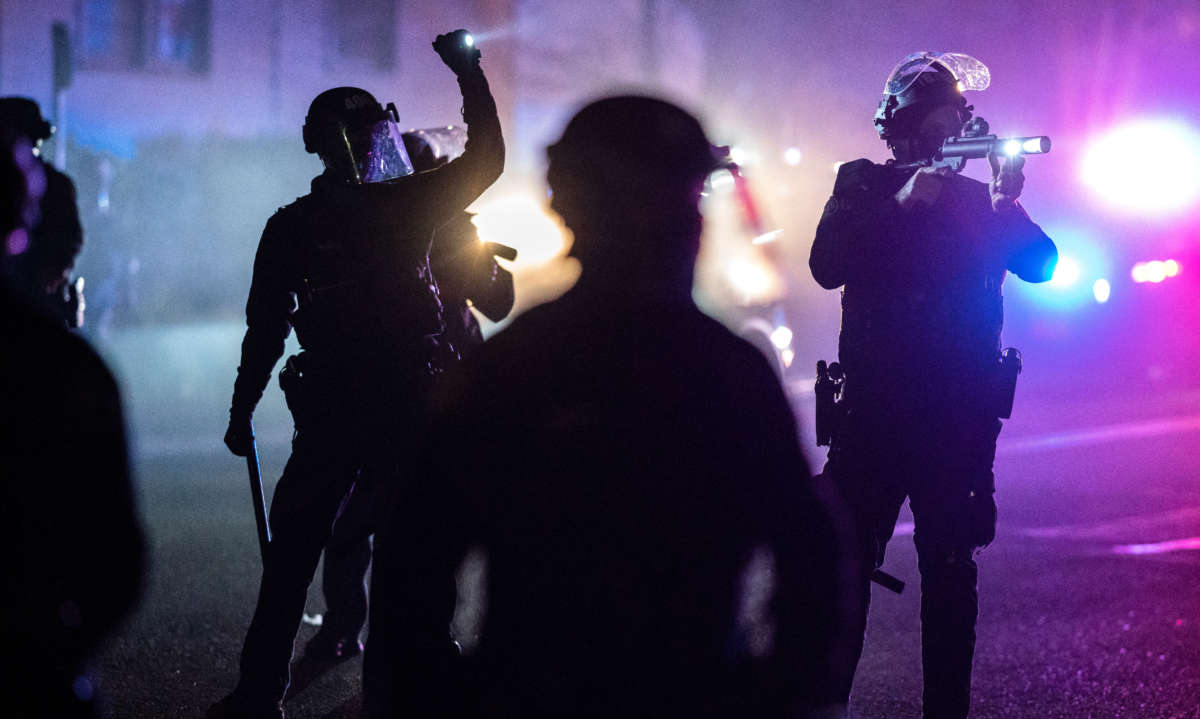 Portland police officers search for stragglers after dispersing a protest against the killing of Daunte Wright on April 12, 2021, in Portland, Oregon.