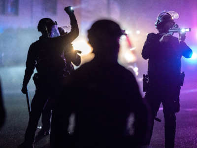 Portland police officers search for stragglers after dispersing a protest against the killing of Daunte Wright on April 12, 2021, in Portland, Oregon.