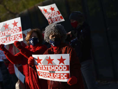Activists hold signs as they take part in a rally in support of D.C. statehood near the U.S. Capitol in Washington, D.C., on March 22, 2021.