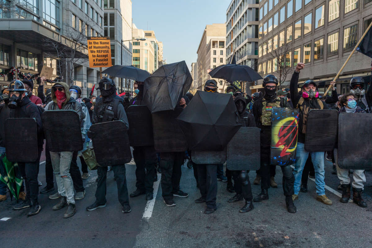 Counter-protesters form a line outside of Black Lives Matter Plaza against a police line separating them from a group of Proud Boys during an anti-Trump rally on the same day as the second Million MAGA March in Washington, D.C., on December 12, 2020.