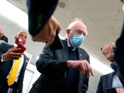 Sen. Bernie Sanders speaks to reporters in the Senate Subway during a roll call vote on April 13, 2021, in Washington, D.C.