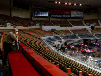An Arizona Ranger watches as contractors working for Cyber Ninjas, who was hired by the Arizona State Senate, examine and recount ballots from the 2020 general election at Veterans Memorial Coliseum on May 1, 2021, in Phoenix, Arizona. The Maricopa County ballot recount comes after two election audits found no evidence of widespread fraud.