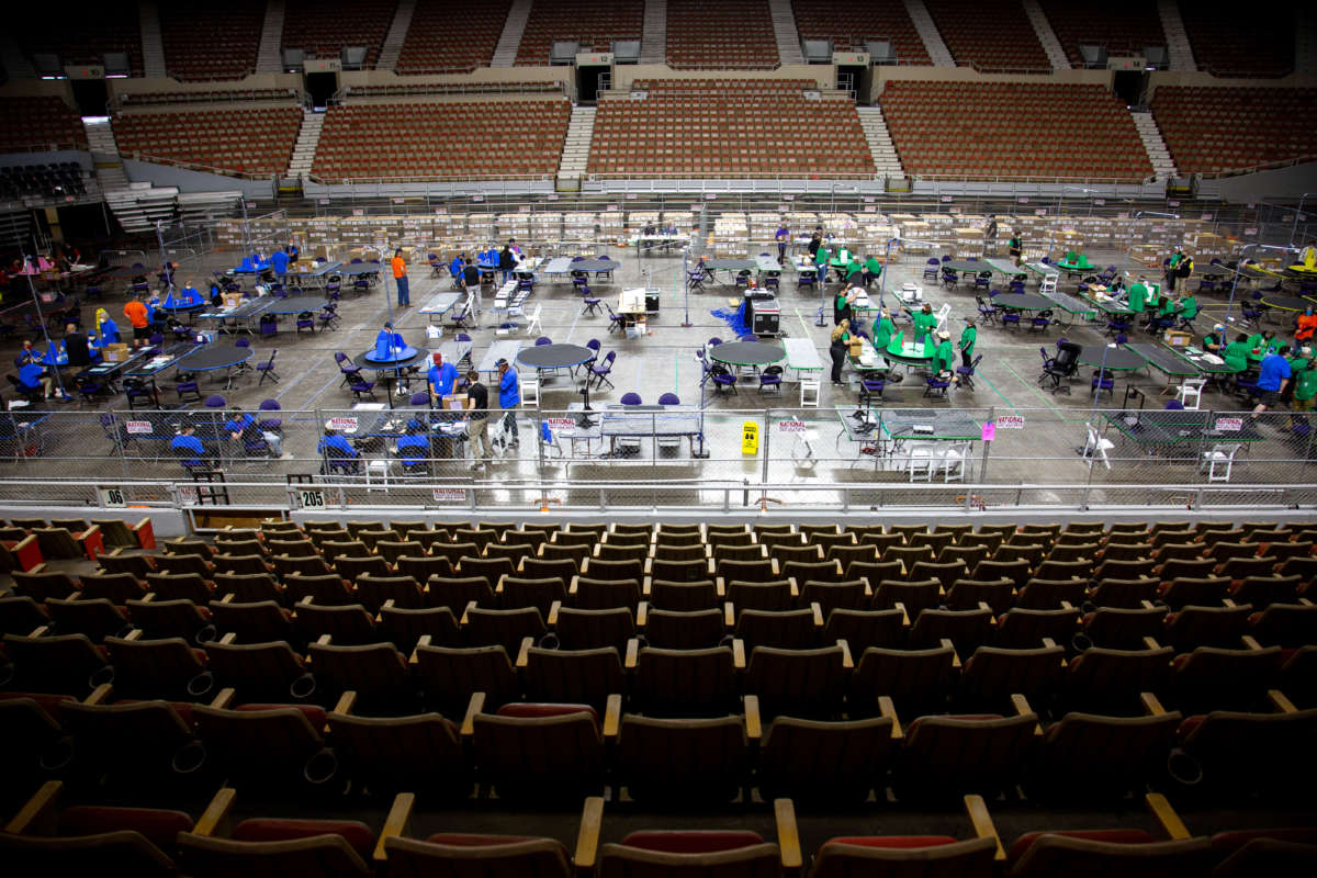 Contractors working for Cyber Ninjas, who was hired by the Arizona State Senate, examine and recount ballots from the 2020 general election at Veterans Memorial Coliseum on May 1, 2021, in Phoenix, Arizona.