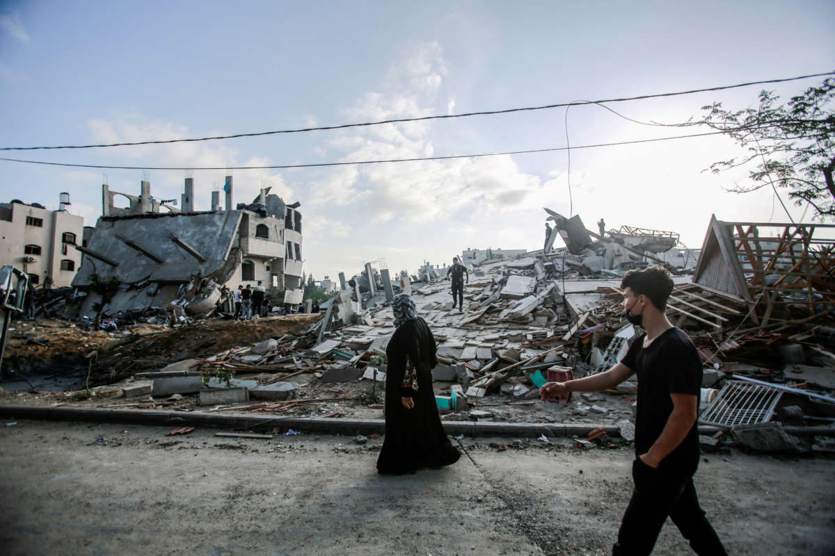 A Palestinian woman inspects her destroyed house after an Israeli air strike in Beit Lahia, on the northern Gaza strip, on May 13, 2021.