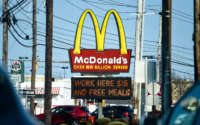 The sign at the McDonald's restaurant on Penn Ave in Sinking Spring, Pennsylvania, on April 8, 2021, with a message on a board below it that reads "Work Here $15 And Free Meals."