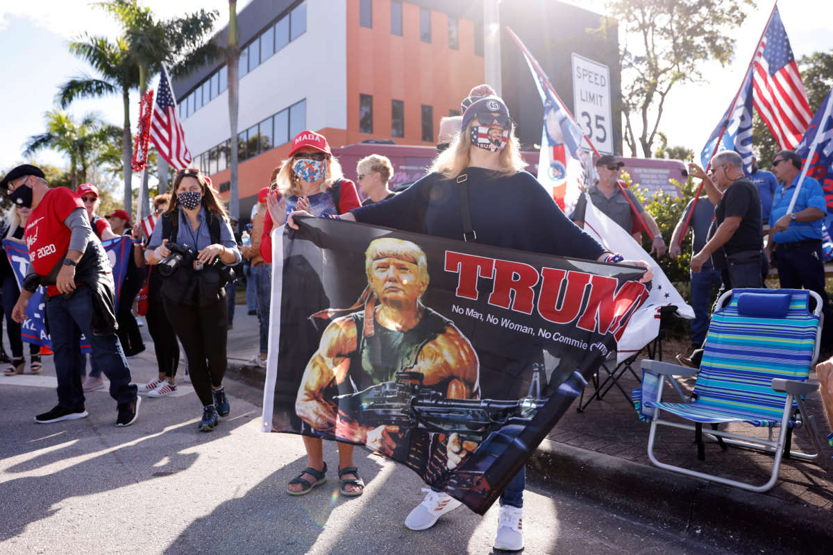 Supporters of outgoing President Donald Trump await his return to Florida along the route leading to his Mar-a-Lago estate on January 20, 2021, in West Palm Beach, Florida.