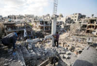 Palestinians search for their belongings while rescue efforts continue to evacuate Palestinians from the rubble of the buildings destroyed by ongoing Israeli airstrikes on Gaza, in Beit Hanoun, Gaza on May 14, 2021.