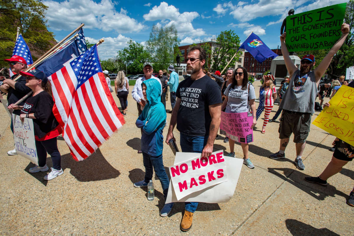 Rally goers protest vaccines and the current administration during the "World Wide Rally for Freedom," an anti-mask and anti-vaccine rally, at the statehouse in Concord, New Hampshire, May 15, 2021.