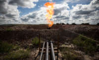 A gas flare is seen at an oil well site on July 26, 2013, outside Williston, North Dakota.