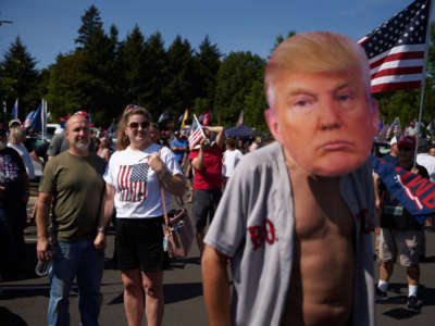 Trump supporters listen to a speaker during a rally and caravan in Oregon City, Oregon, on September 7, 2020.
