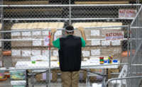 A contractor working for Cyber Ninjas, who was hired by the Arizona State Senate, looks at ballots from the 2020 general election on May 3, 2021, in Phoenix, Arizona.