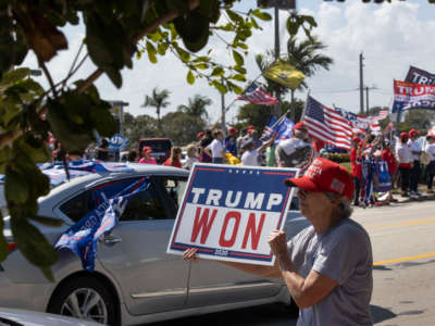 Supporters of former President Donald Trump gather along Southern Blvd. near Trump's Mar-a-Lago home on February 15, 2021, in West Palm Beach, Florida.