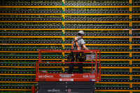 A technician inspects hardware used for bitcoin mining at Bitfarms in Saint Hyacinthe, Quebec, on March 19, 2018.