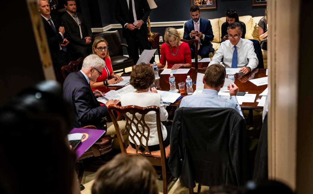 Senators Bill Cassidy, Kyrsten Sinema, Lisa Murkowski and Mitt Romney hold a bipartisan meeting on infrastructure in the basement of the U.S. Capitol building on June 8, 2021, in Washington, D.C.