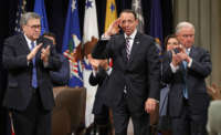 From left, Attorney General William Barr, Deputy Attorney General Rod Rosenstein and former U.S. Attorney General Jeff Sessions applaud during Rosenstein's farewell ceremony at the Robert F. Kennedy Main Justice Building on May 9, 2019, in Washington, D.C.