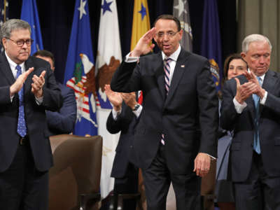 From left, Attorney General William Barr, Deputy Attorney General Rod Rosenstein and former U.S. Attorney General Jeff Sessions applaud during Rosenstein's farewell ceremony at the Robert F. Kennedy Main Justice Building on May 9, 2019, in Washington, D.C.