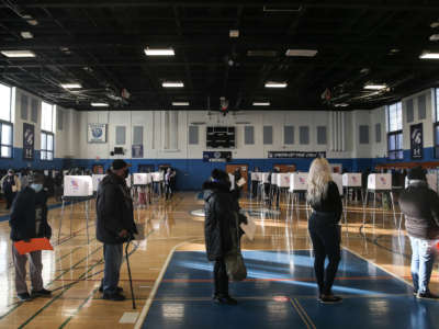 Residents of Baltimore City line up to cast their votes in the U.S. Presidential and local congressional elections at Carver Vocational Technical School on November 3, 2020, in Baltimore, Maryland.
