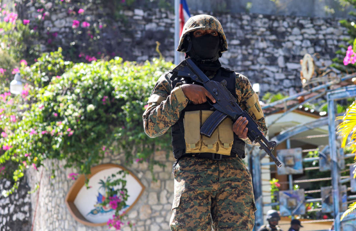 A Haitian police officer stands guard outside of the presidential residence on July 7, 2021, in Port-au-Prince, Haiti.