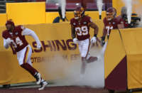 Washington Football Team members run onto the field on December 27, 2020, at FedEx Field in Landover, Maryland.