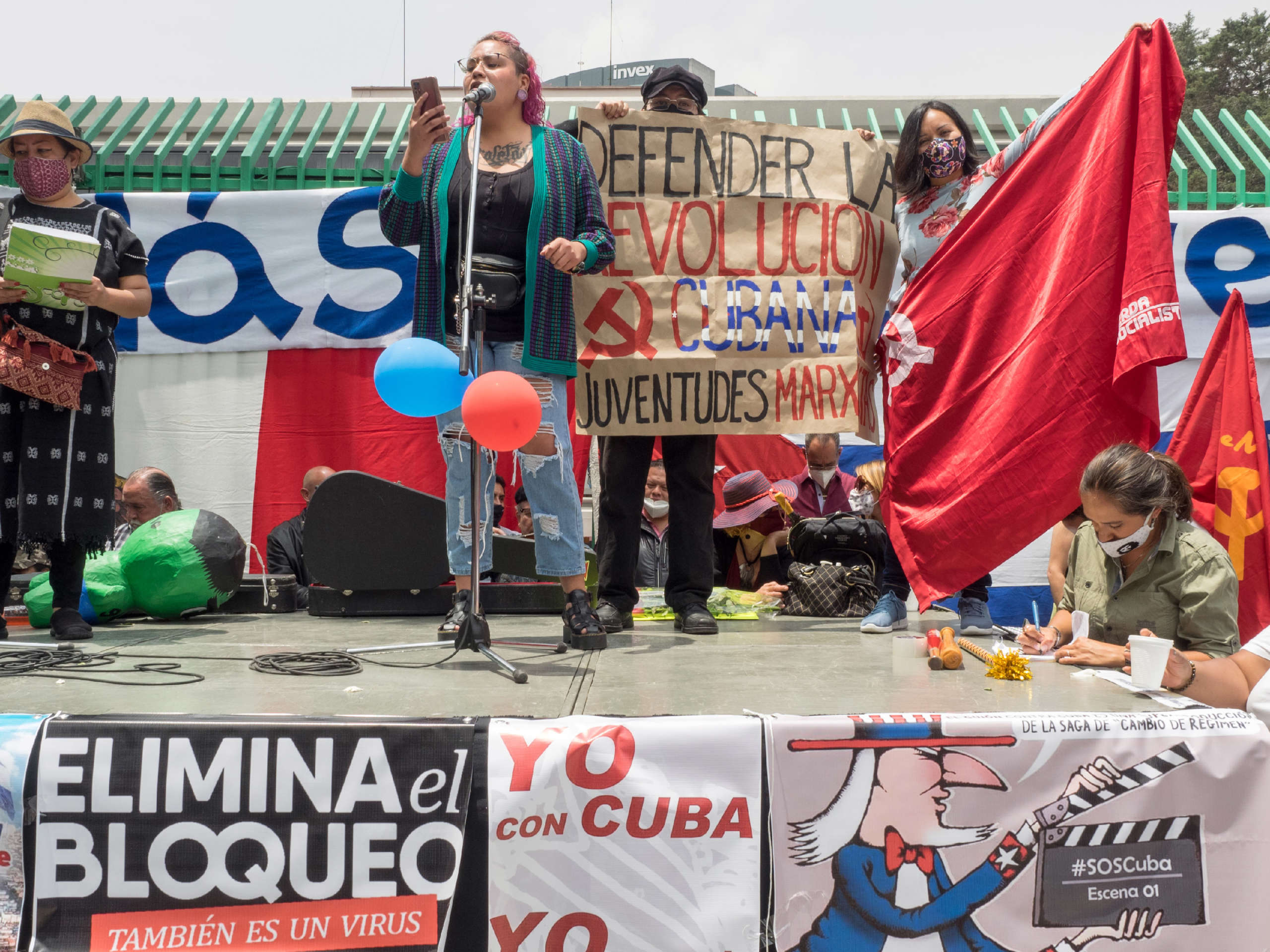 A speaker reads a statement to the assembled crowd during a demonstration in solidarity with the Cuban Revolution in front of the Cuban embassy in Mexico City, Mexico, July 17, 2021.