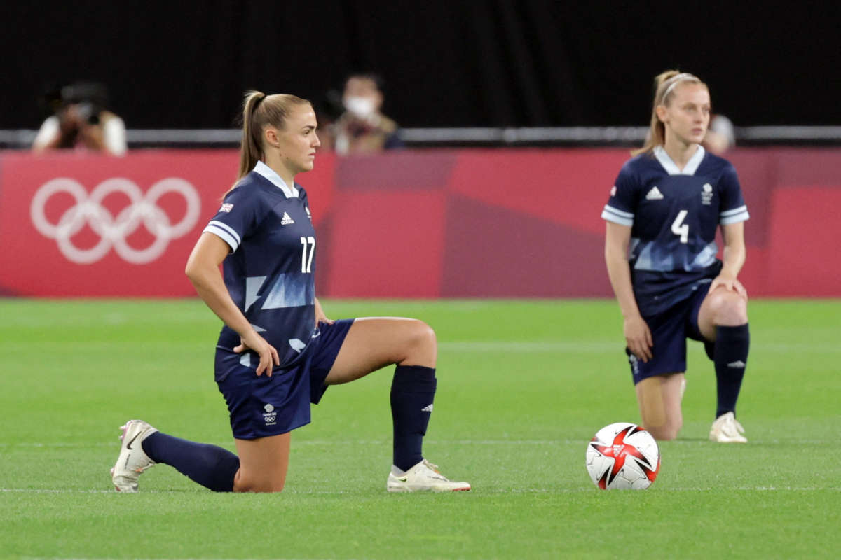 Britain's forward Georgia Stanway, left, and midfielder Keira Walsh take a knee before the Tokyo 2020 Olympic Games women's group E first round football match between Great Britain and Chile at the Sapporo Dome in Sapporo on July 21, 2021.