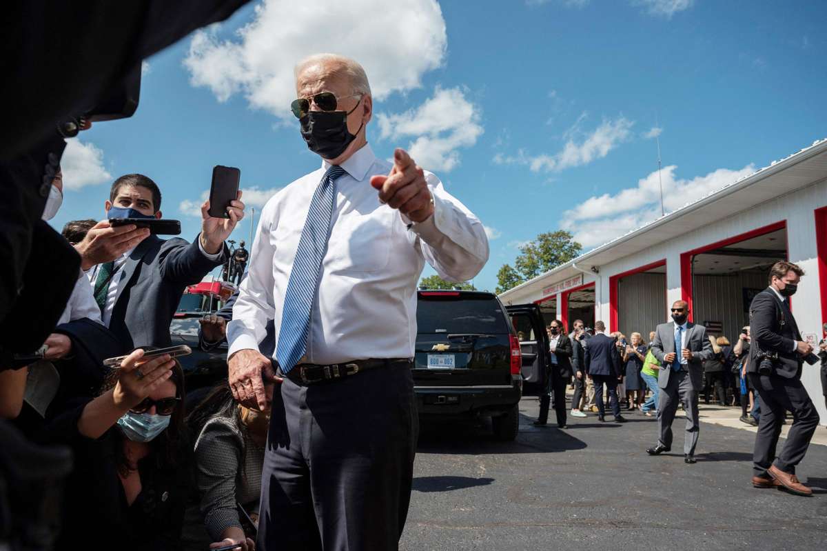 Joe Biden points while glaring through his aviator sunglasses