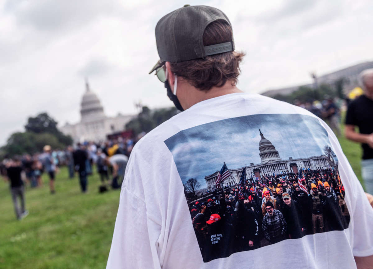 A getty photo of a man wearing a shirt of a getty photo of the January 6th capitol riots
