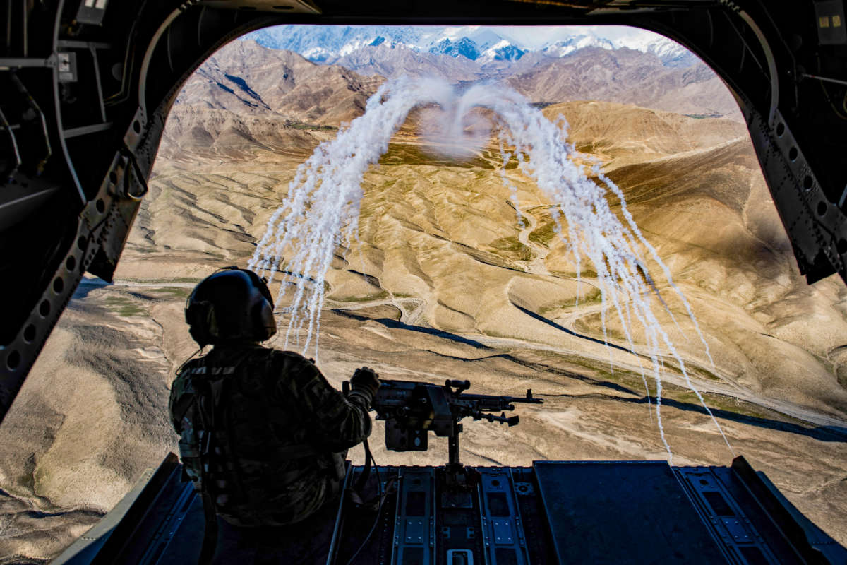 An Army crew chief aboard a CH-47F Chinook helicopter observes a test of threat countermeasures during a training flight in Afghanistan, March 14, 2018.