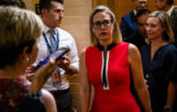 Sen. Kyrsten Sinema heads back to a bipartisan meeting on infrastructure in the basement of the U.S. Capitol building on June 8, 2021, in Washington, D.C.