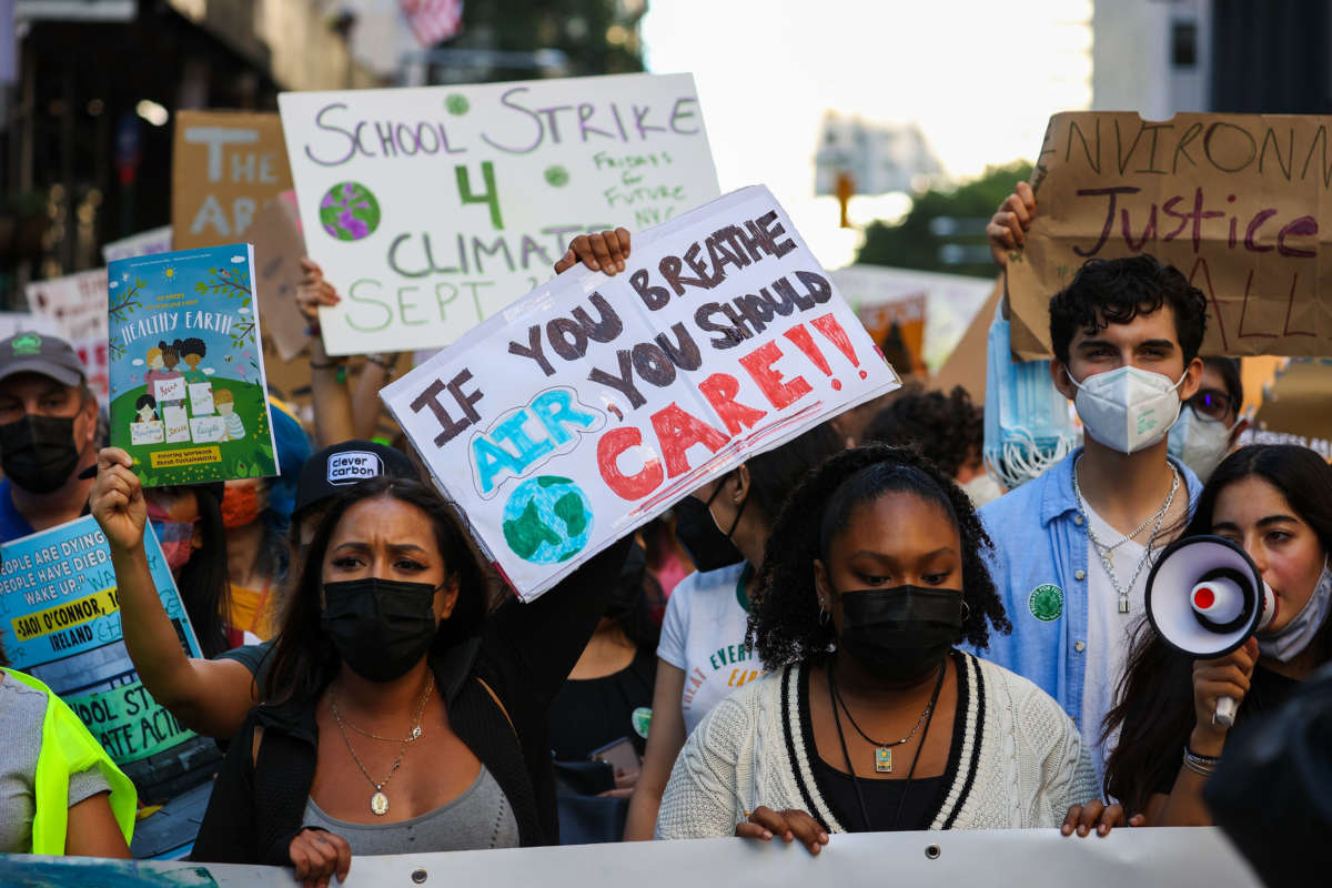 Hundreds protest to raise awareness of climate change while marching down to the Battery Park of Manhattan in New York City on September 24, 2021.