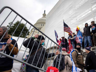 Trump supporters clash with police and security forces as people try to storm the U.S. Capitol in Washington, D.C., on January 6, 2021.