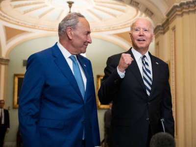 Senate Majority Leader Chuck Schumer and President Joe Biden speak briefly to reporters as they arrive at the U.S. Capitol for a Senate Democratic luncheon on July 14, 2021, in Washington, D.C.