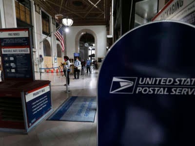 People wait for service at a post office in New York City on August 19, 2020.