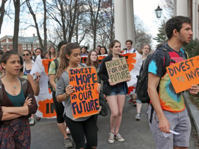 Students and alumni at Tufts University protest near the Tufts University presidents office in Medford, Massachusetts, on April 22, 2015, and began a sit-in that they said would continue until the administration commits to fossil fuel divestment.