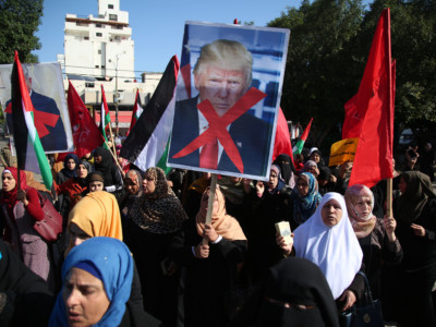 Palestinian women hold banners during a protest against US President Donald Trump's decision to recognize Jerusalem as the capital of Israel, in Gaza City on December 17, 2017.