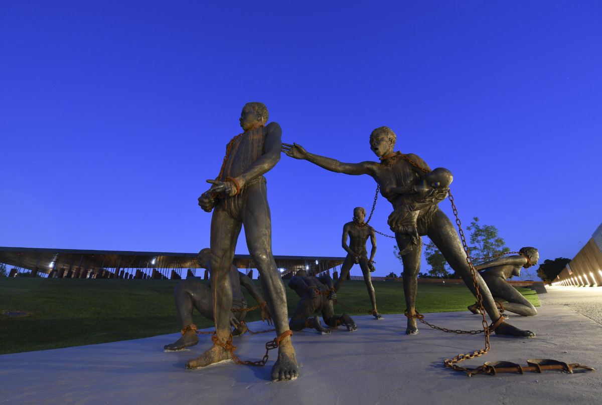 A sculpture by artist Kwame Akoto-Bamfo, part of the Nkyinkyim Installation, of enslaved people in chains is shown after entering The National Memorial for Peace and Justice on April 20, 2018, in Montgomery, Al.