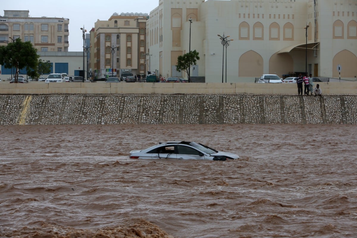 A picture taken on May 26, 2018, shows a car stuck in a flooded street in the city of Salalah, Oman, after Cyclone Mekunu dumped two years' worth of rain in 24 hours.