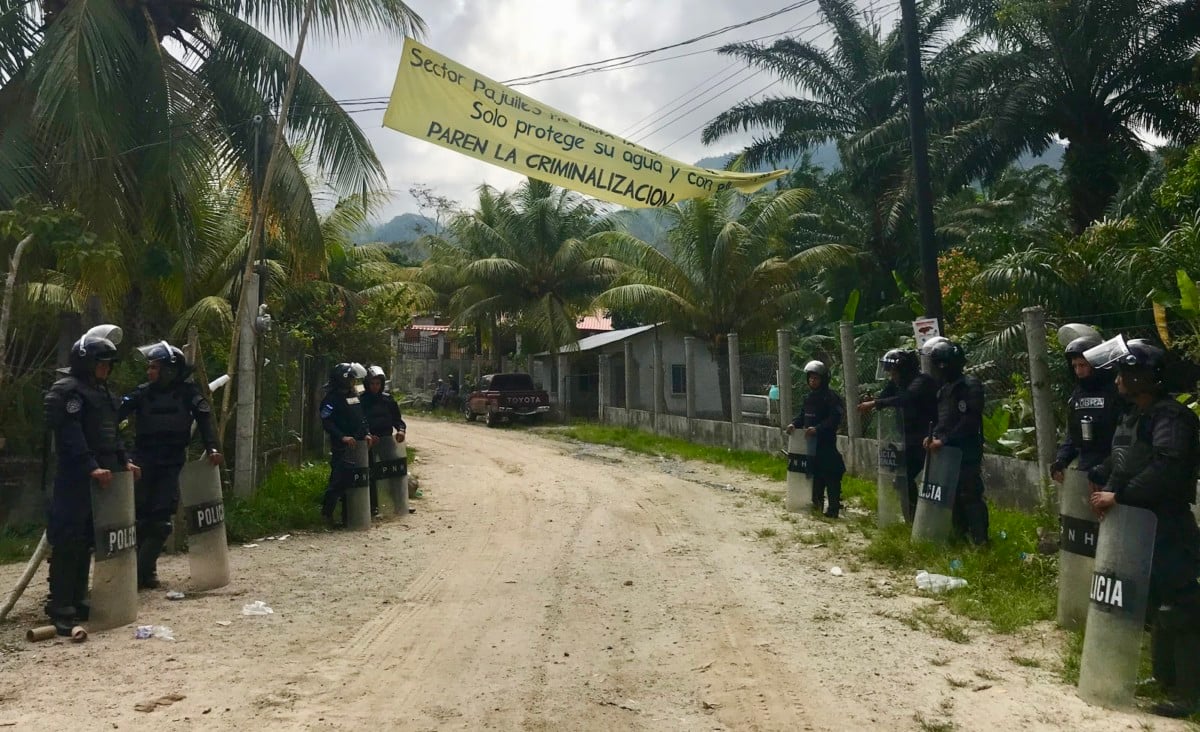 Police from various units are present May 3 in Pajuiles, in northern Honduras, to escort dam construction machinery past a community resistance camp.