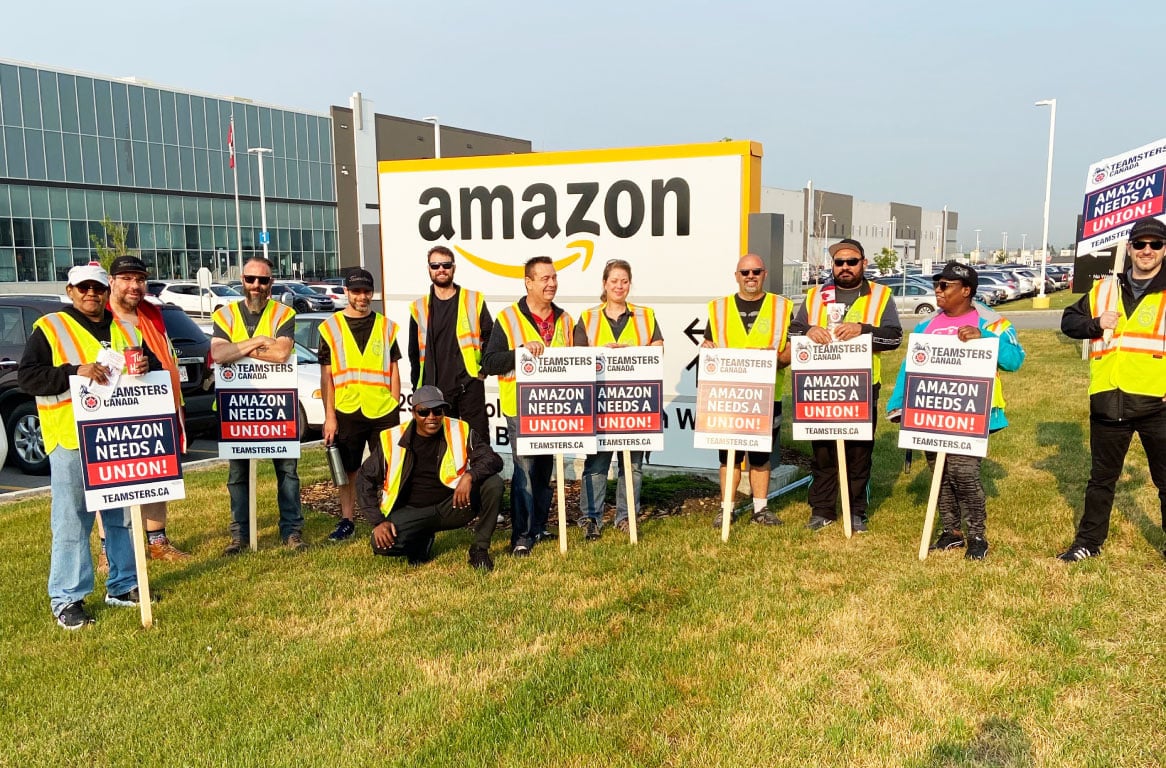 Members of Teamsters Locals 987 and 362 protest outside an Amazon fulfillment center in Alberta, Canada, on July 14, 2021, after meeting with Amazon workers across the country to discuss working conditions and union organizing.