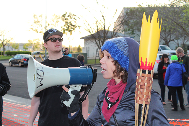Delphine Brody, local activist, on the bullhorn. (Photo: Dan Bacher)