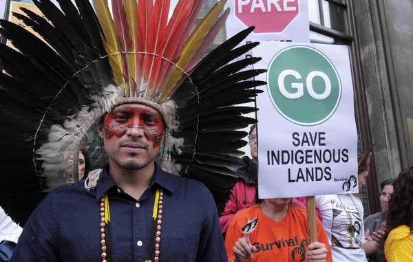 Wearing his traditional headdress and facial decoration, Nixiwaka led a protest against Brazil's assault on indigenous rights in London in October 2013. (Photo: © Survival International)