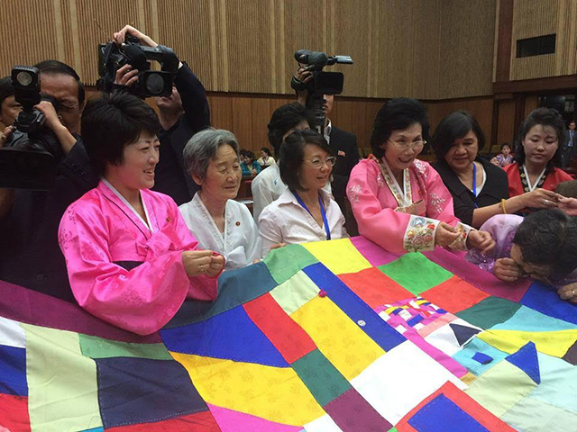 Jogakbo ceremony of stitching Korea back together at the end of Pyongyang Peace Symposium with North Korean women. (Photo: Niana Liu)