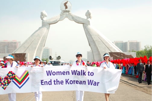 Photo of Women Cross DMZ walk in Pyongyang, North Korea, at the Monument of Reunification. (Photo: Niana Liu)