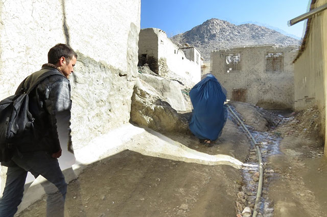 Going up the hill. The water pipe can be seen in a gulley. Zuhair's mother walks in front of Zek. (Photo: Dr. Hakim)